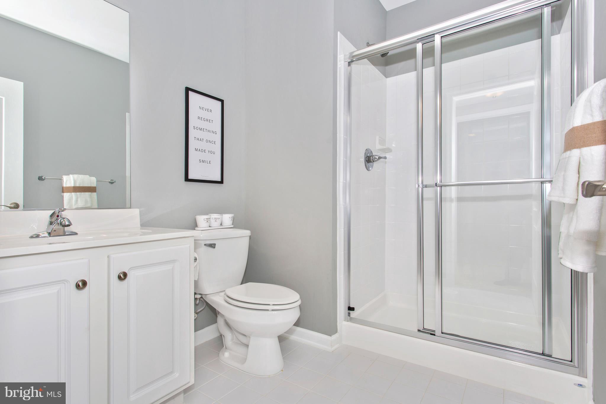 2112 Gable Drive Jessup, MD 20794 - Photo 23 of 27 a bathroom with a shower a sink a toilet and a mirror