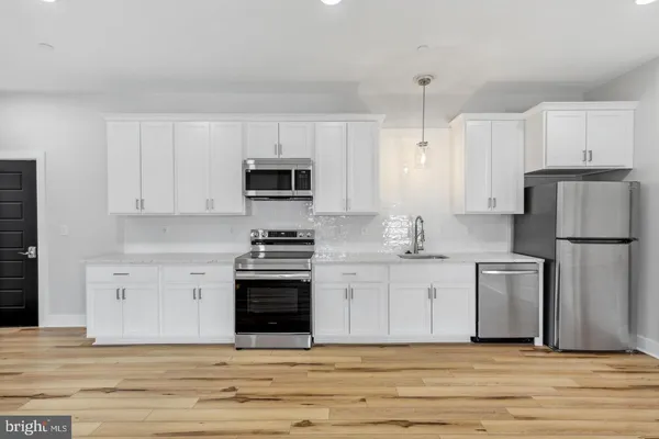 a kitchen with a sink stove and refrigerator