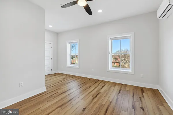 wooden floor in an empty room with a window