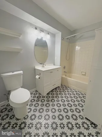 a bathroom with a toilet and a mirror