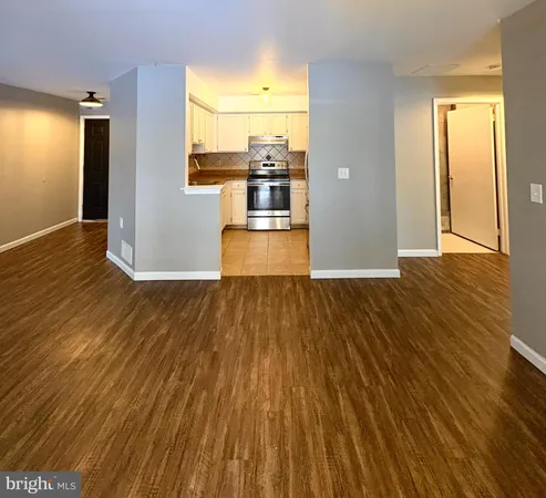 a view of a living room with wooden floor