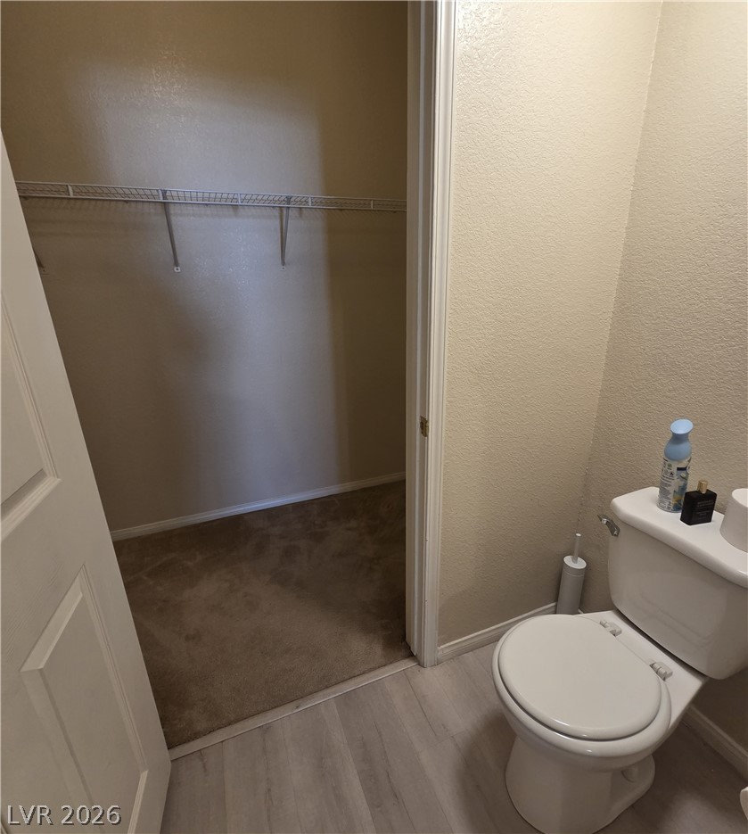 10550 West Alexander Road, Unit 2183 Las Vegas, NV 89129 - Photo 13 of 22 An organized closet offers practical storage adjacent to a pristine bathroom.