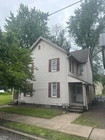 a front view of a house with a yard