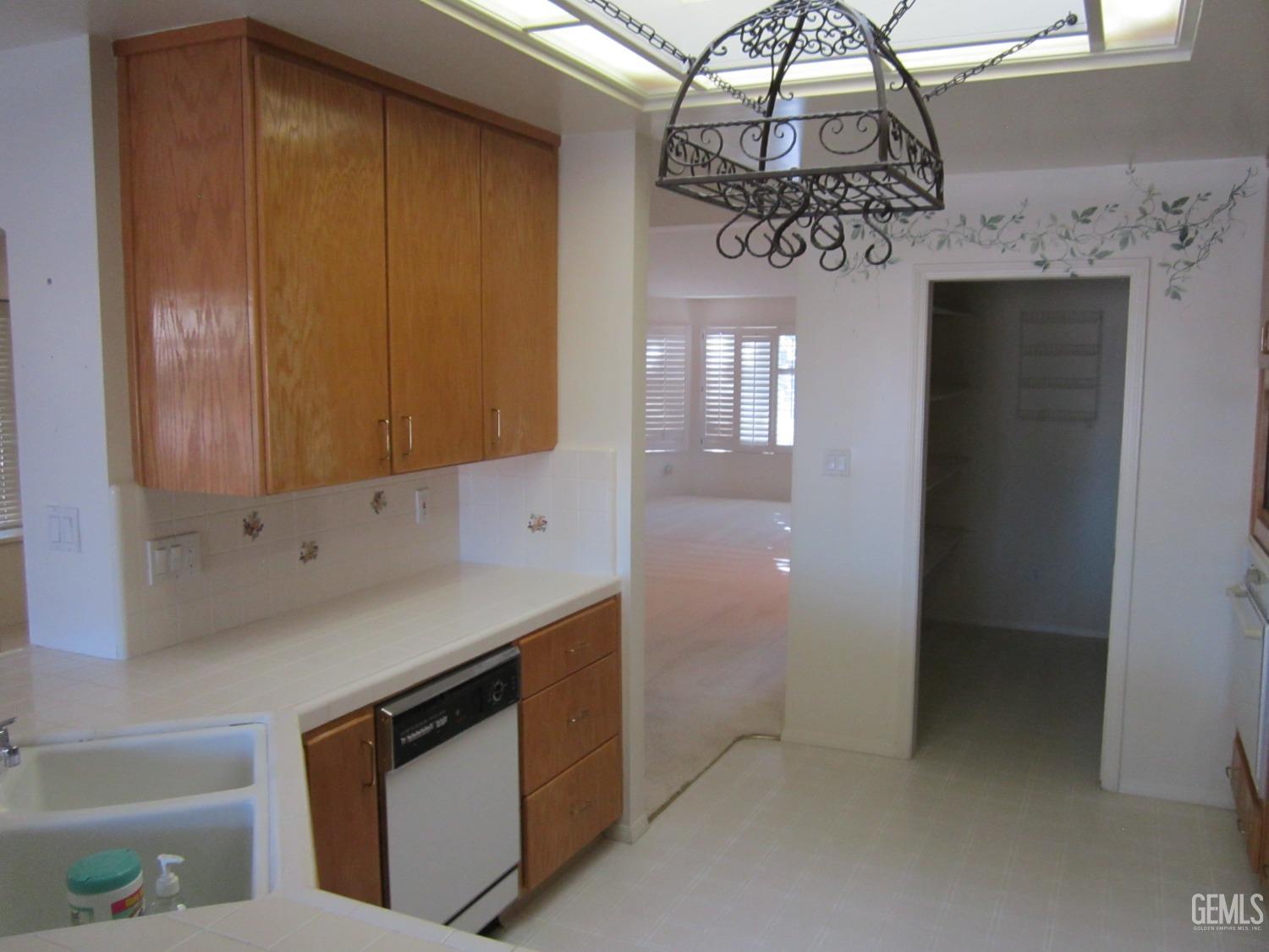 Undisclosed Address Bakersfield, CA 93314 - Photo 16 of 34 a kitchen with stainless steel appliances granite countertop a sink and cabinets