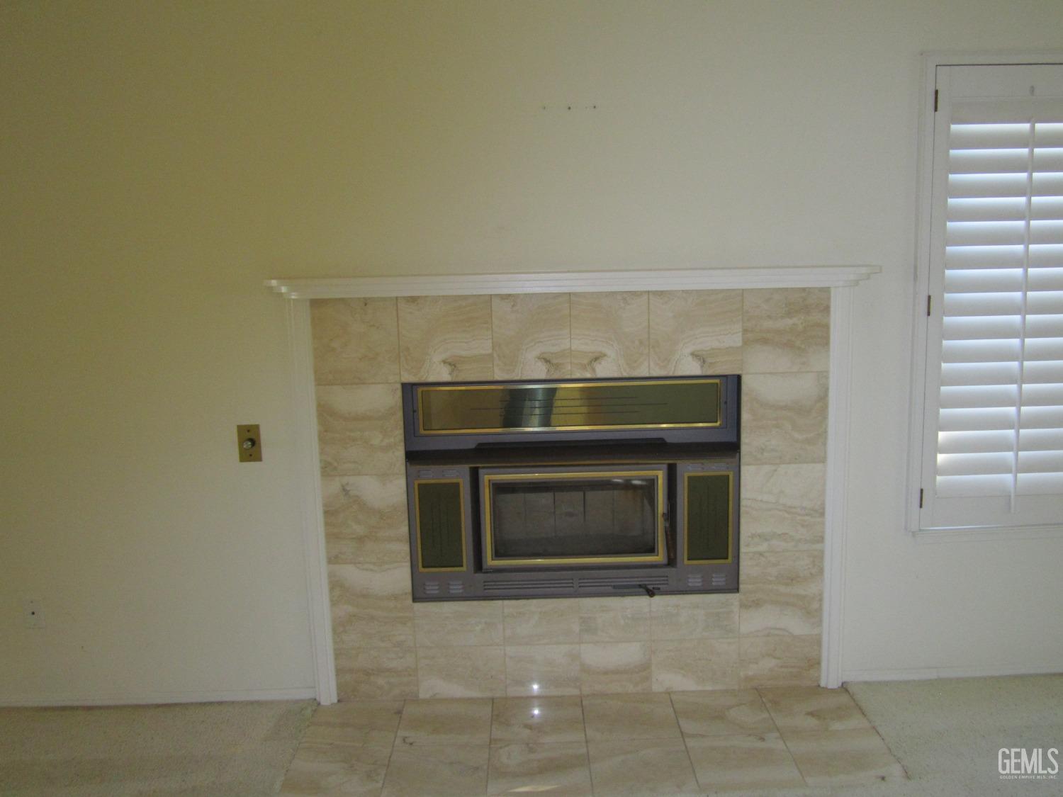 Undisclosed Address Bakersfield, CA 93314 - Photo 19 of 34 a living room with a fireplace