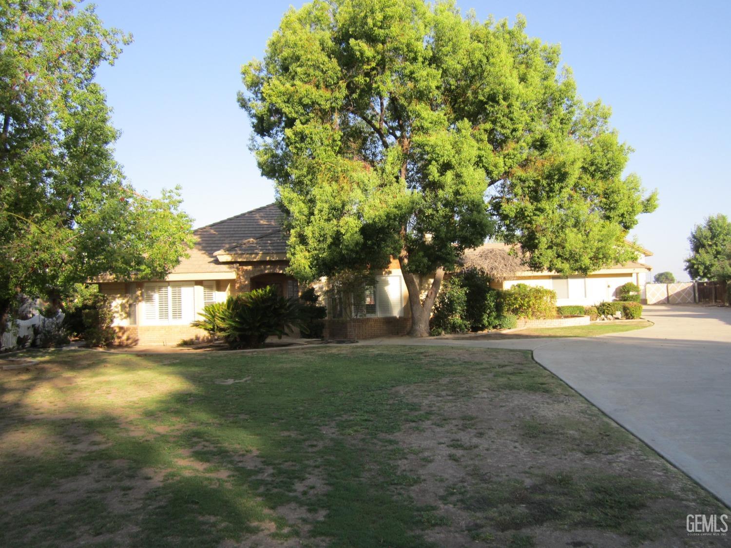 Undisclosed Address Bakersfield, CA 93314 - Photo 2 of 34 a view of a yard with a house