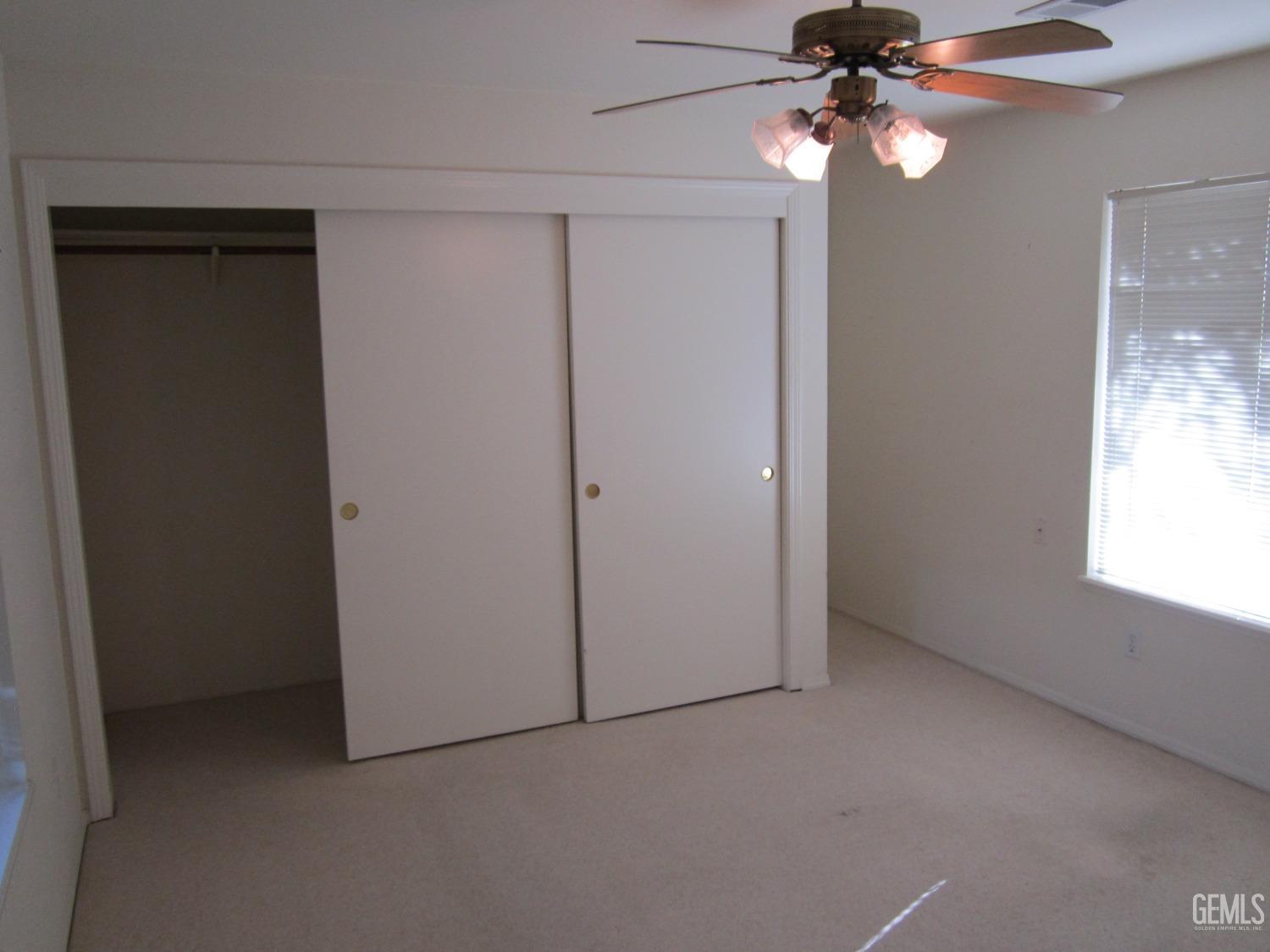 Undisclosed Address Bakersfield, CA 93314 - Photo 22 of 34 an empty room with a window and a fan