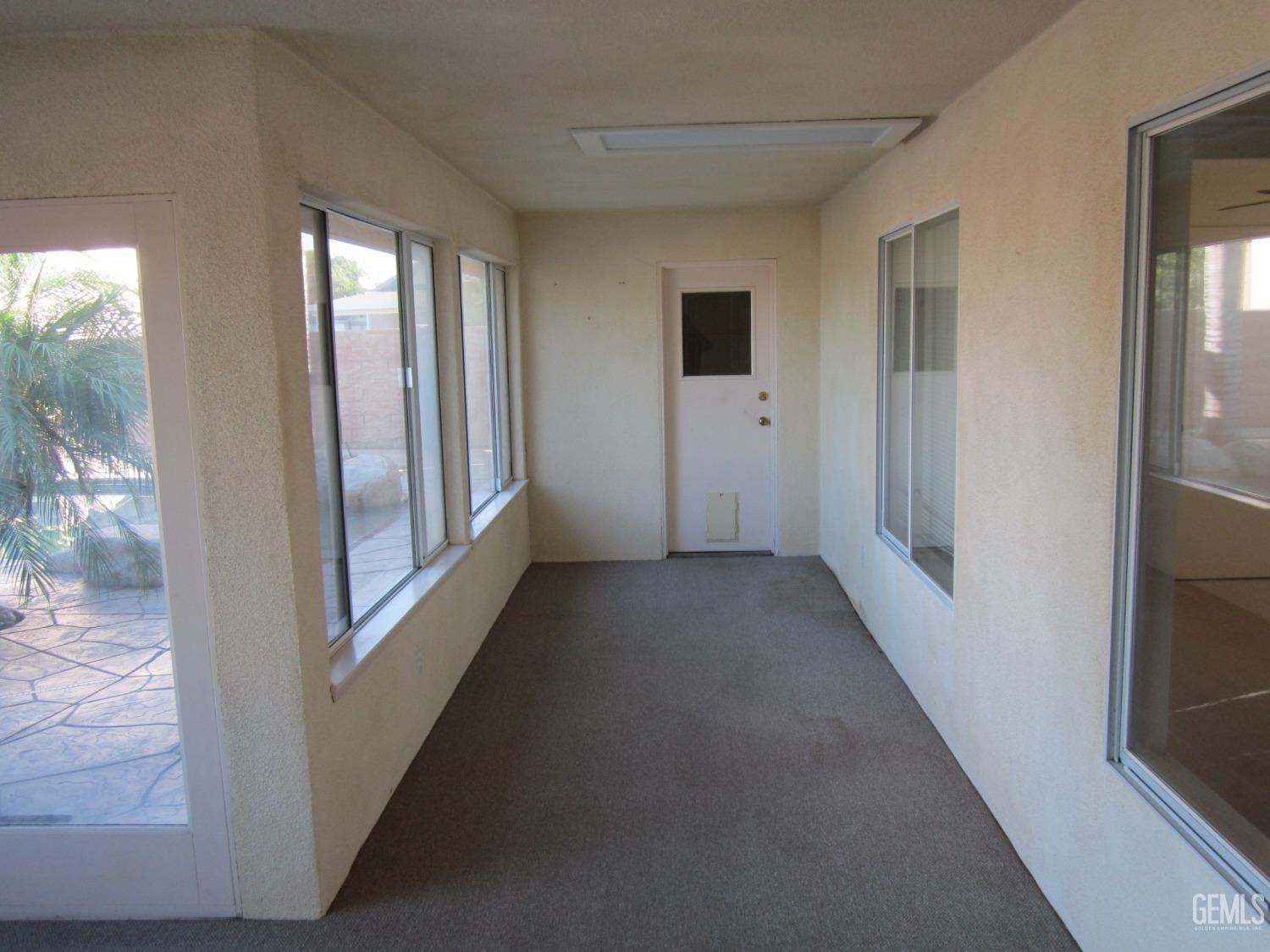 Undisclosed Address Bakersfield, CA 93314 - Photo 24 of 34 a view of a hallway with wooden floor and windows