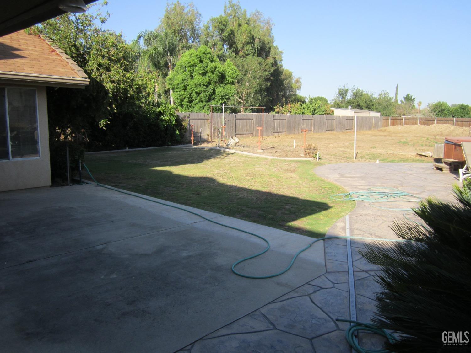 Undisclosed Address Bakersfield, CA 93314 - Photo 29 of 34 a view of a swimming pool with an outdoor seating and a yard