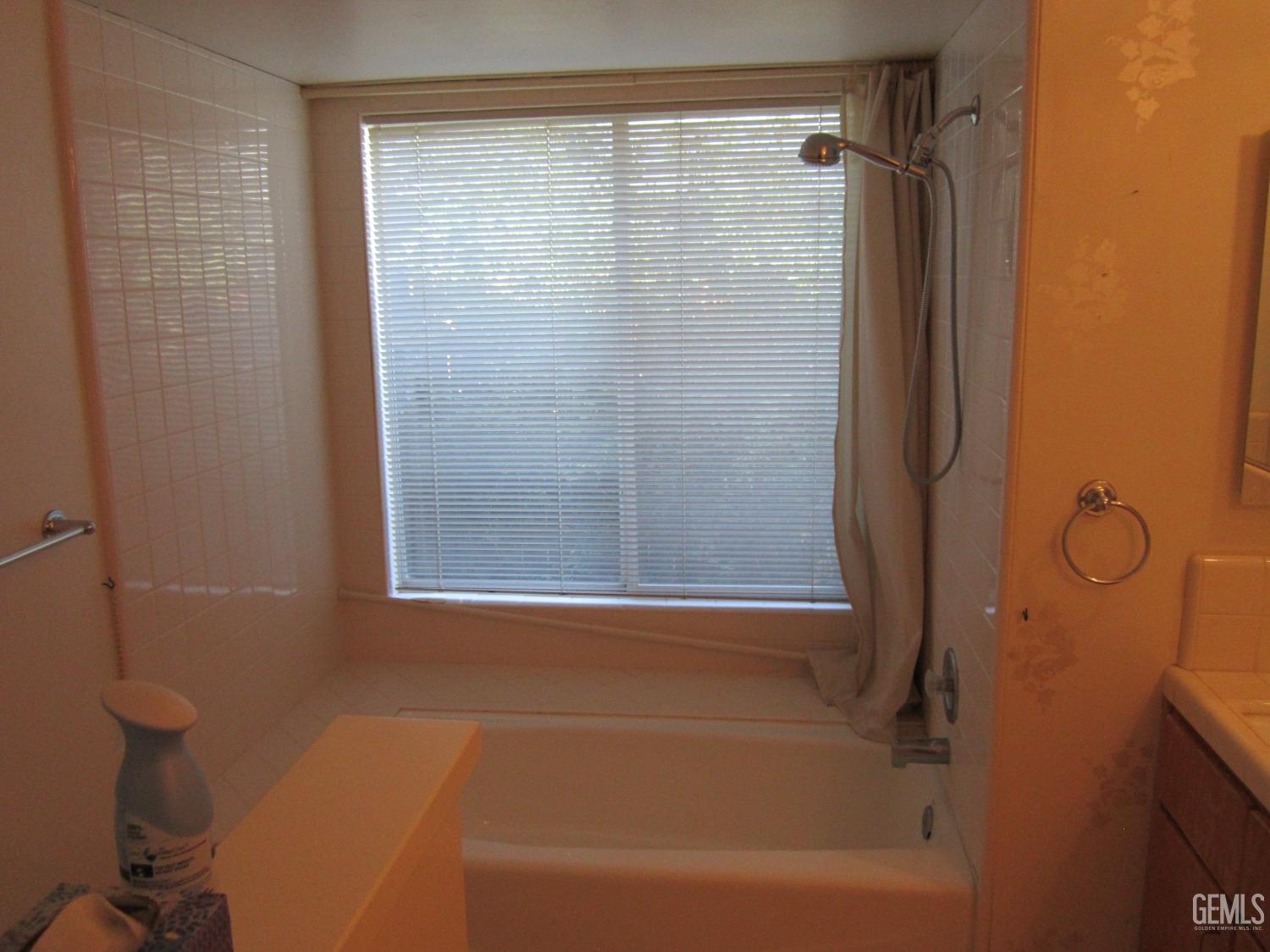 Undisclosed Address Bakersfield, CA 93314 - Photo 6 of 34 a bathroom with a shower and a bath tub