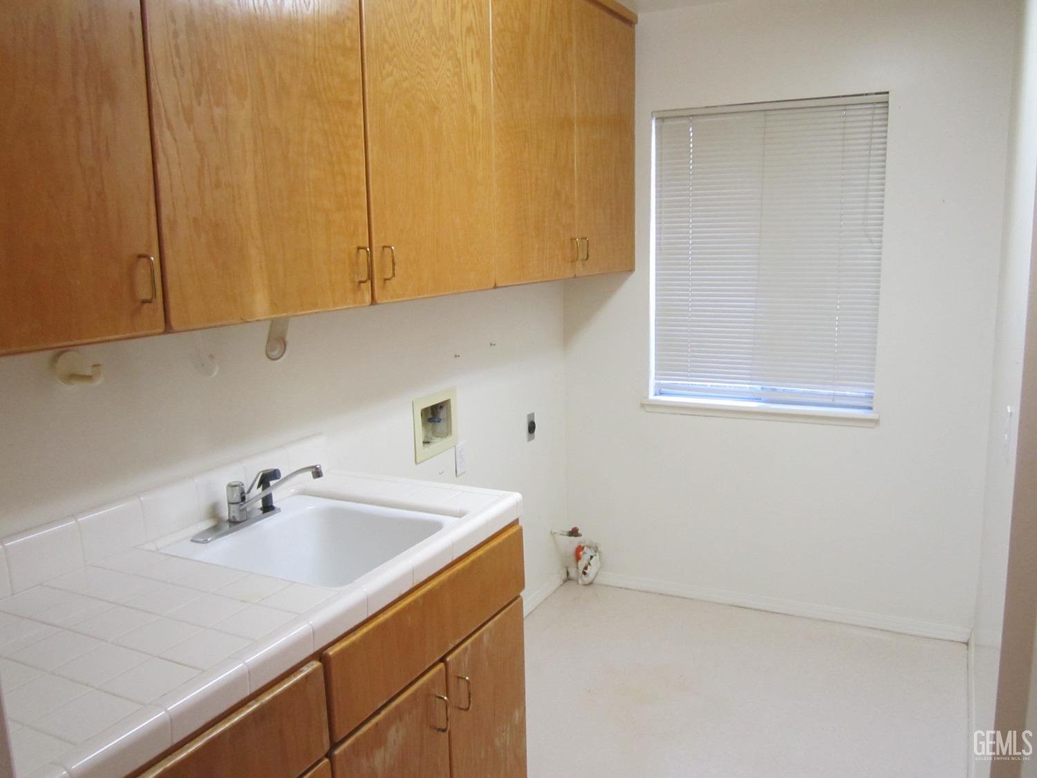 Undisclosed Address Bakersfield, CA 93314 - Photo 7 of 34 a bathroom with a sink and cabinets