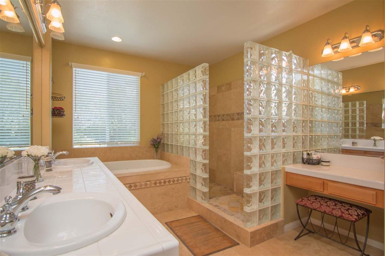 1243 Mariposa Road Carlsbad, CA 92011 - Photo 15 of 25 Many designer touches in this master bath include stone shower and tub, Travertine floors, and glass block shower enclosure.