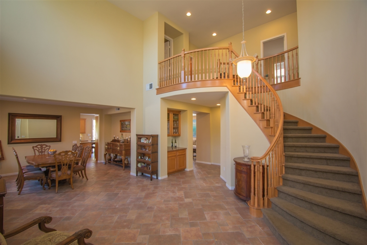1243 Mariposa Road Carlsbad, CA 92011 - Photo 3 of 25 Elegant entry into the living room has two story ceilings and sweeping maple staircase.