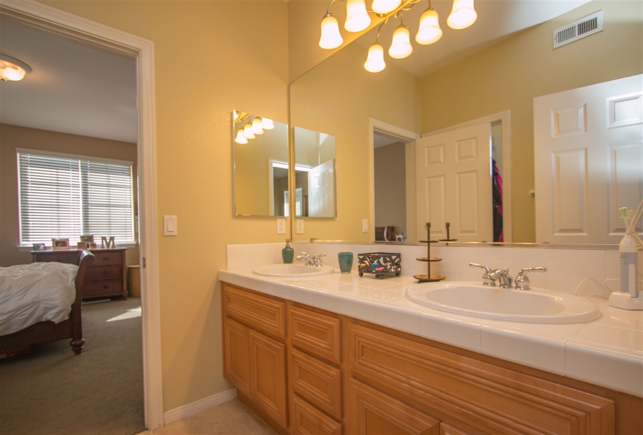 1243 Mariposa Road Carlsbad, CA 92011 - Photo 22 of 25 This is the Jack-n-Jill bathroom with dual sinks and private bathing area.