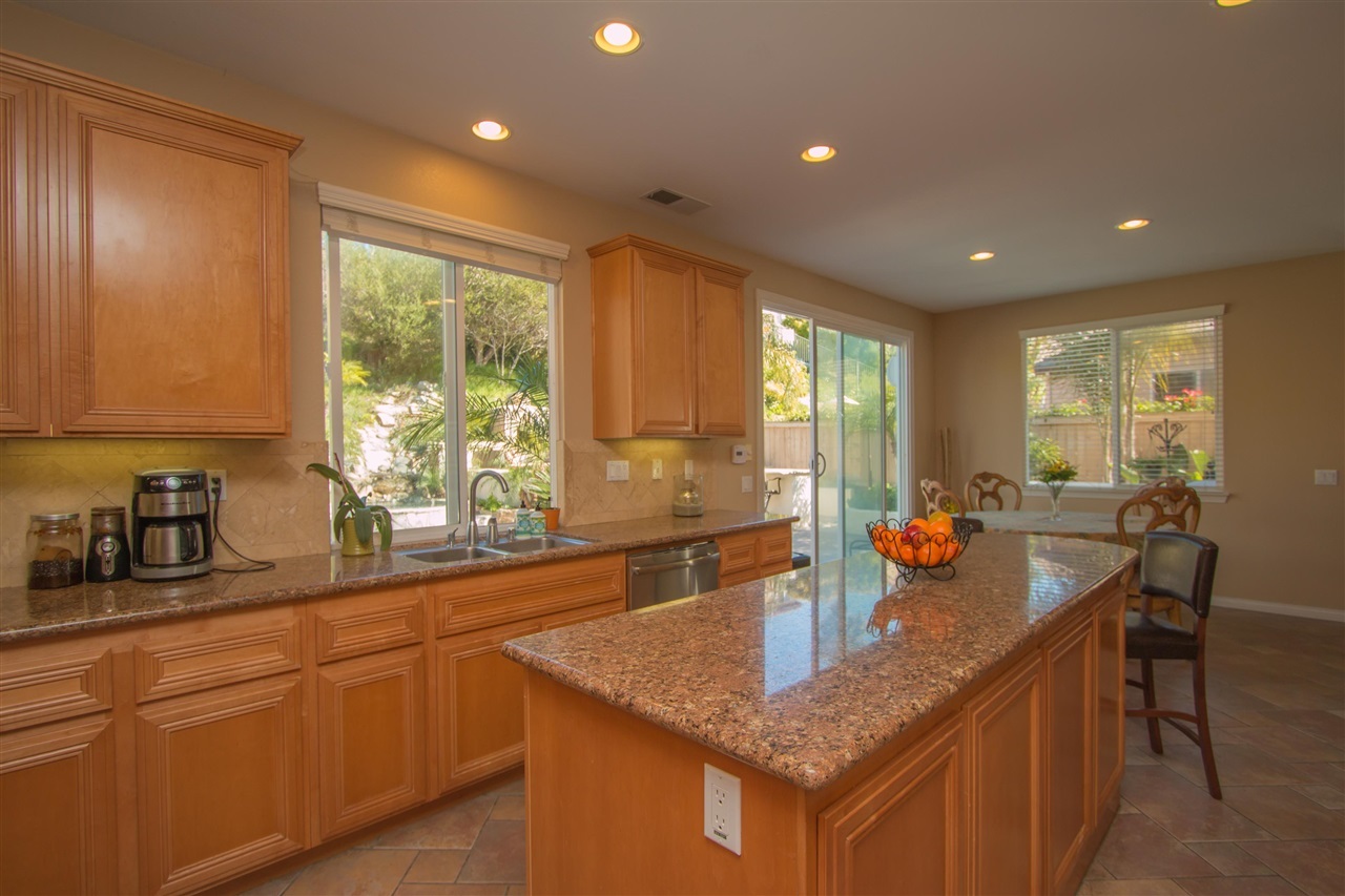 1243 Mariposa Road Carlsbad, CA 92011 - Photo 5 of 25 The kitchen has a large center island and plenty of windows to enjoy the views of the pool!