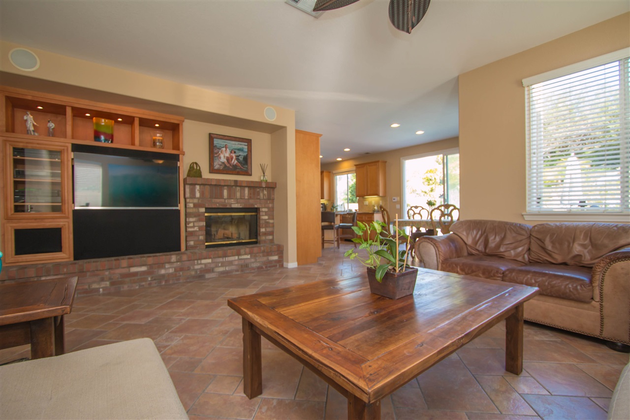 1243 Mariposa Road Carlsbad, CA 92011 - Photo 6 of 25 The spacious family room has a beautiful brick fireplace and built-in media niche with space for a large flat screen TV!