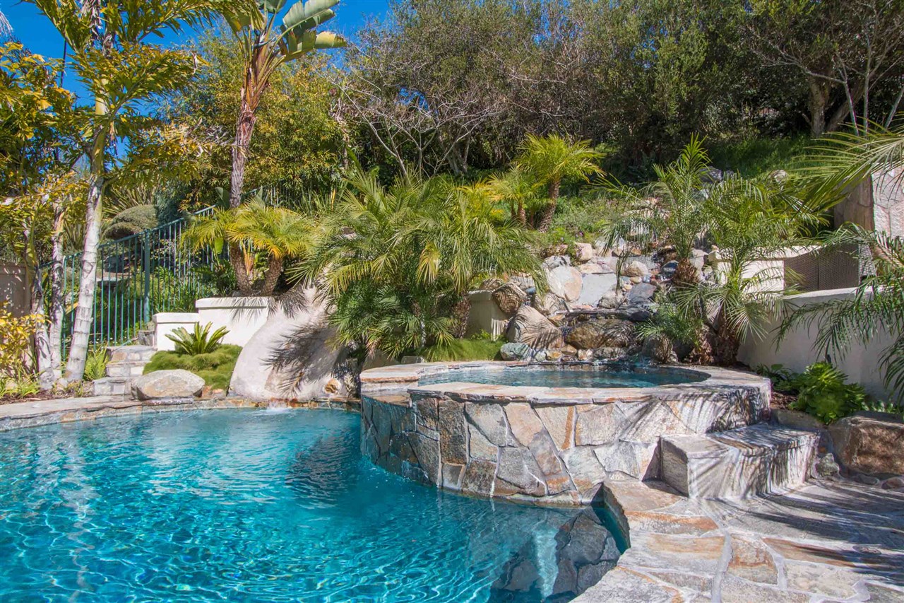 1243 Mariposa Road Carlsbad, CA 92011 - Photo 7 of 25 This view shows the pool, spa, waterfall, built-in slide and custom stone hardscape.