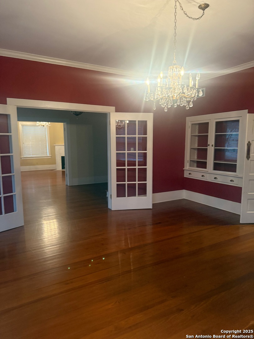 415 North Park Street Uvalde, TX 78801 - Photo 6 of 12 a view of an empty room with wooden floor and windows