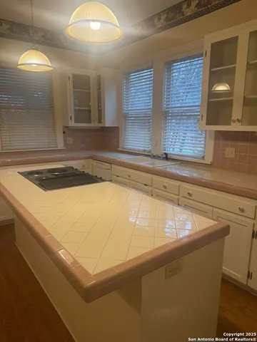 a view of kitchen cabinets and sink