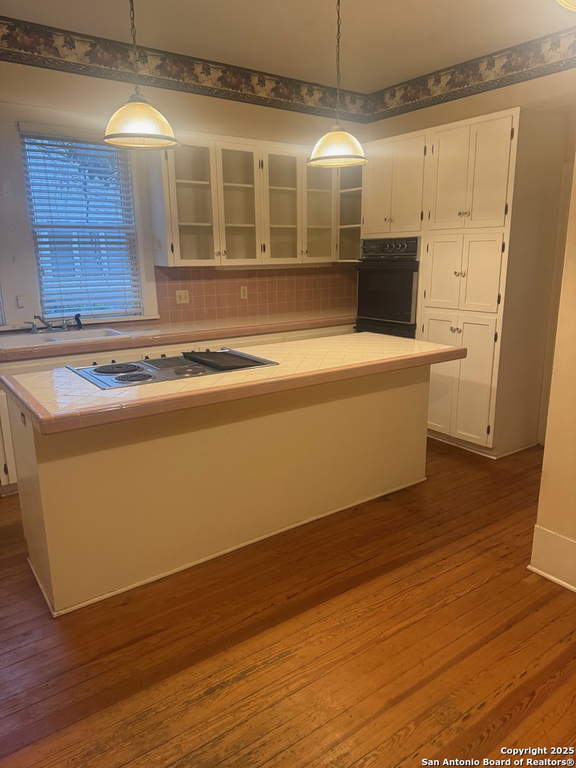 415 North Park Street Uvalde, TX 78801 - Photo 10 of 12 a view of a kitchen with wooden floor and a sink