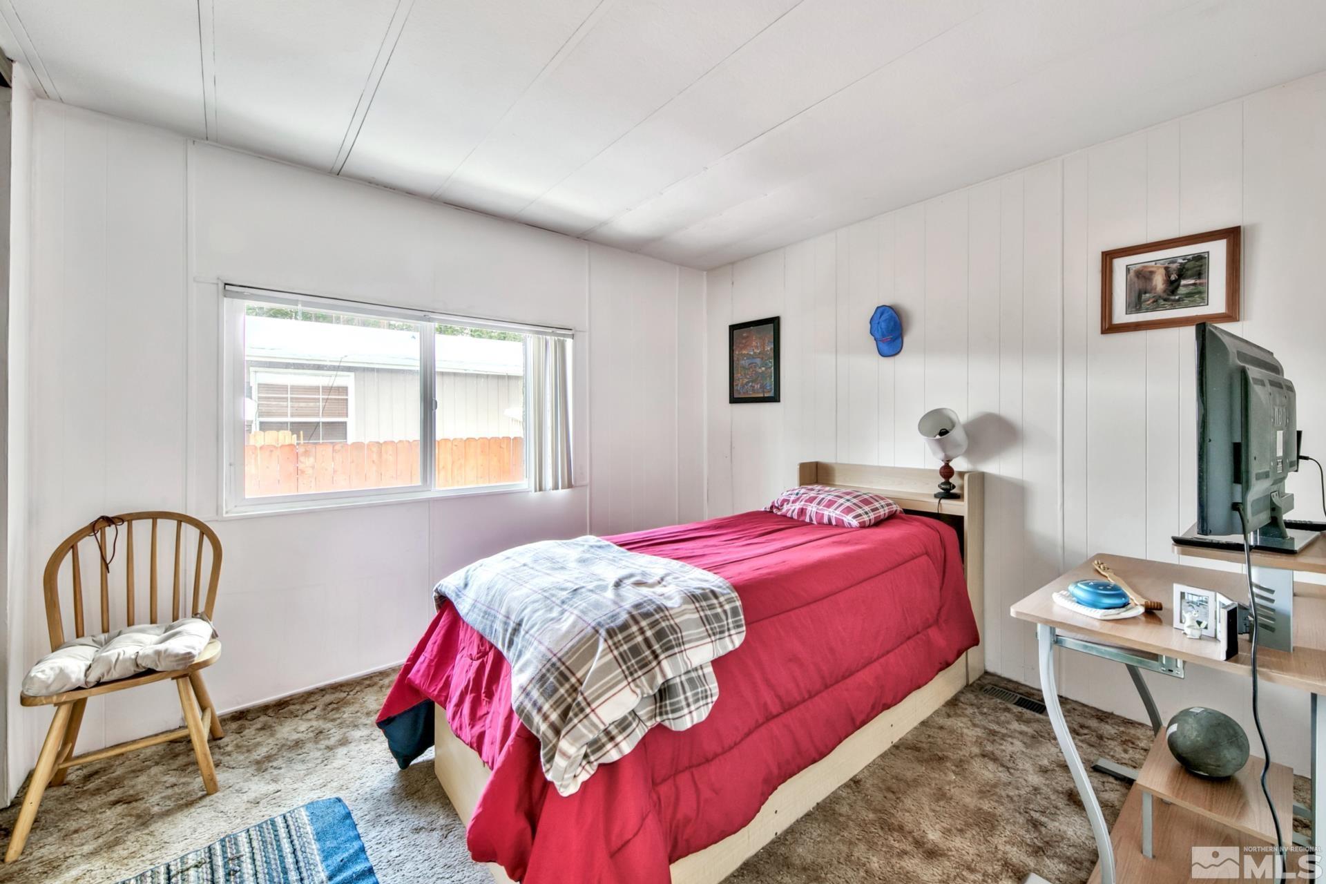 167 Crescent Drive Stateline, NV 89449 - Photo 16 of 23 a bedroom with a bed and a chair