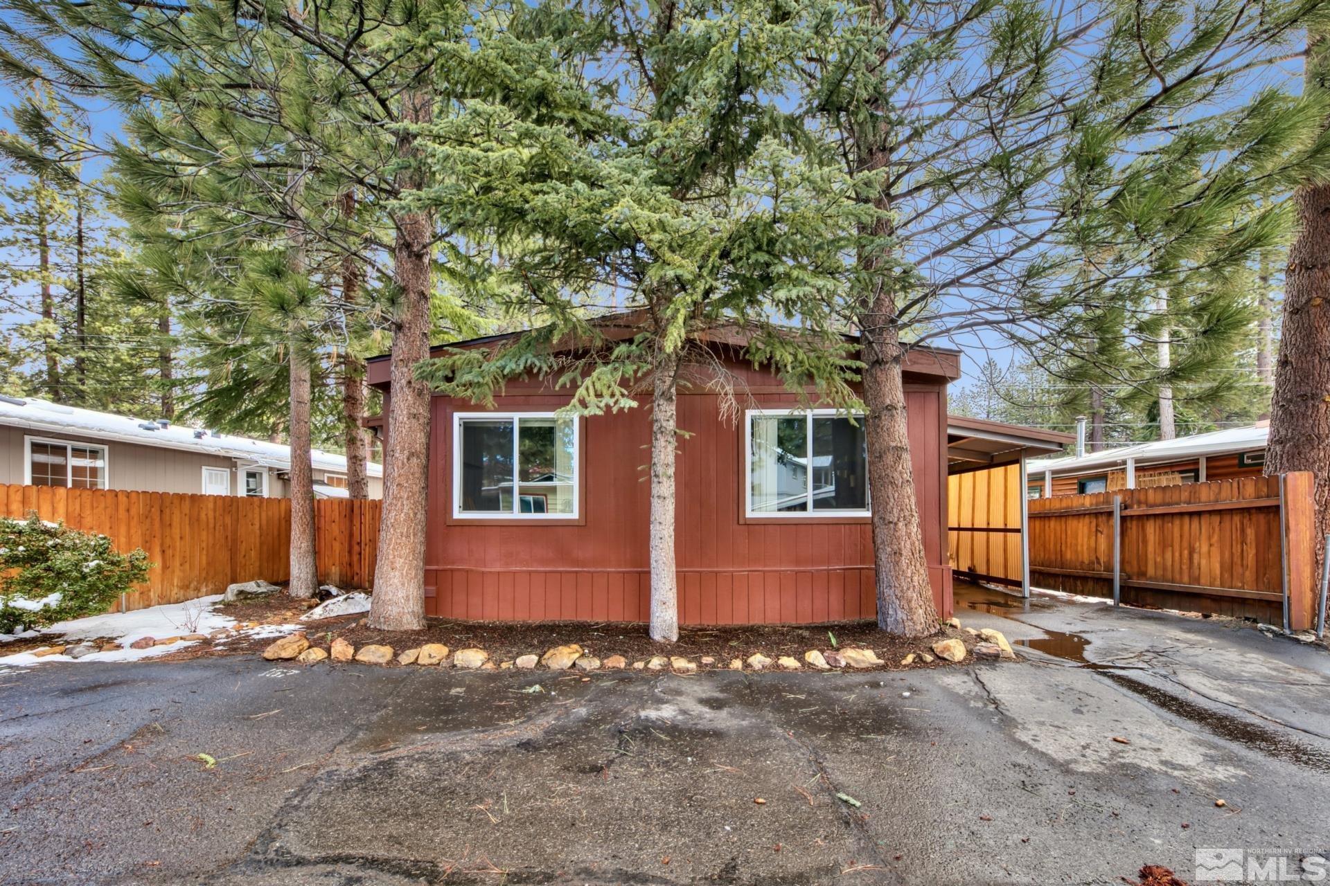 167 Crescent Drive Stateline, NV 89449 - Photo 2 of 23 a view of a house with a tree and wooden fence