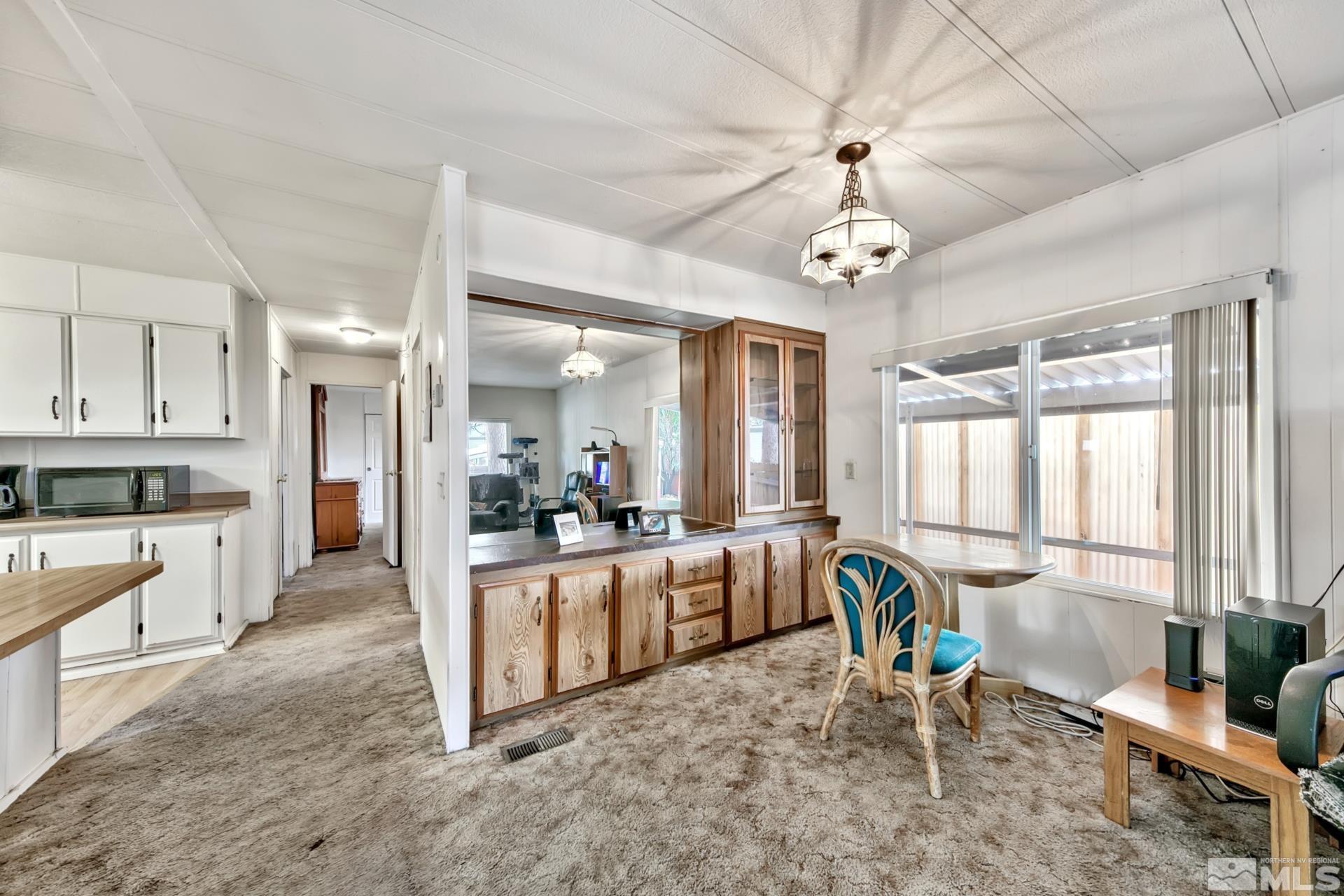 167 Crescent Drive Stateline, NV 89449 - Photo 21 of 23 a living room with stainless steel appliances granite countertop furniture a fireplace a flat screen tv and windows