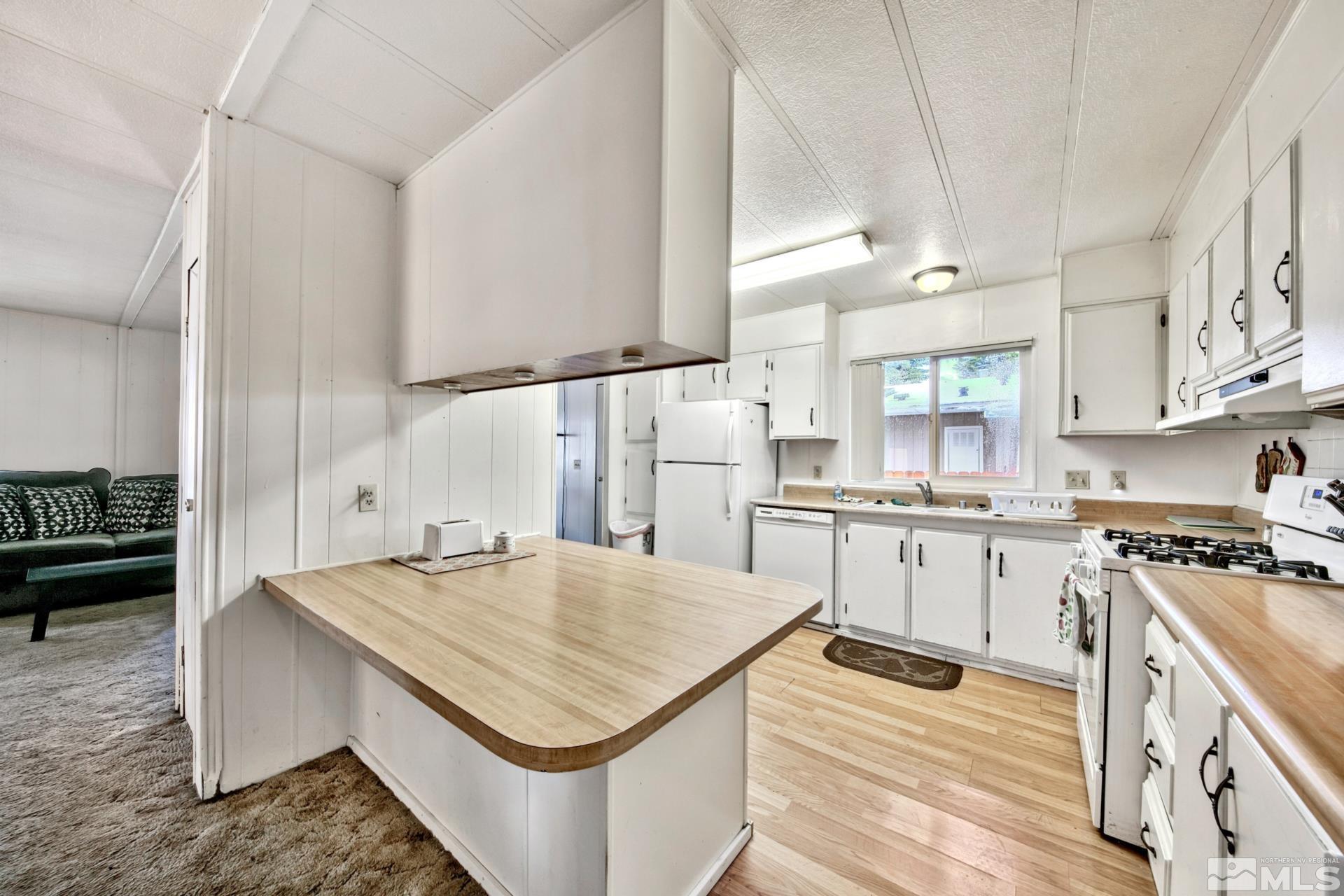 167 Crescent Drive Stateline, NV 89449 - Photo 4 of 23 a kitchen with a stove sink and cabinets