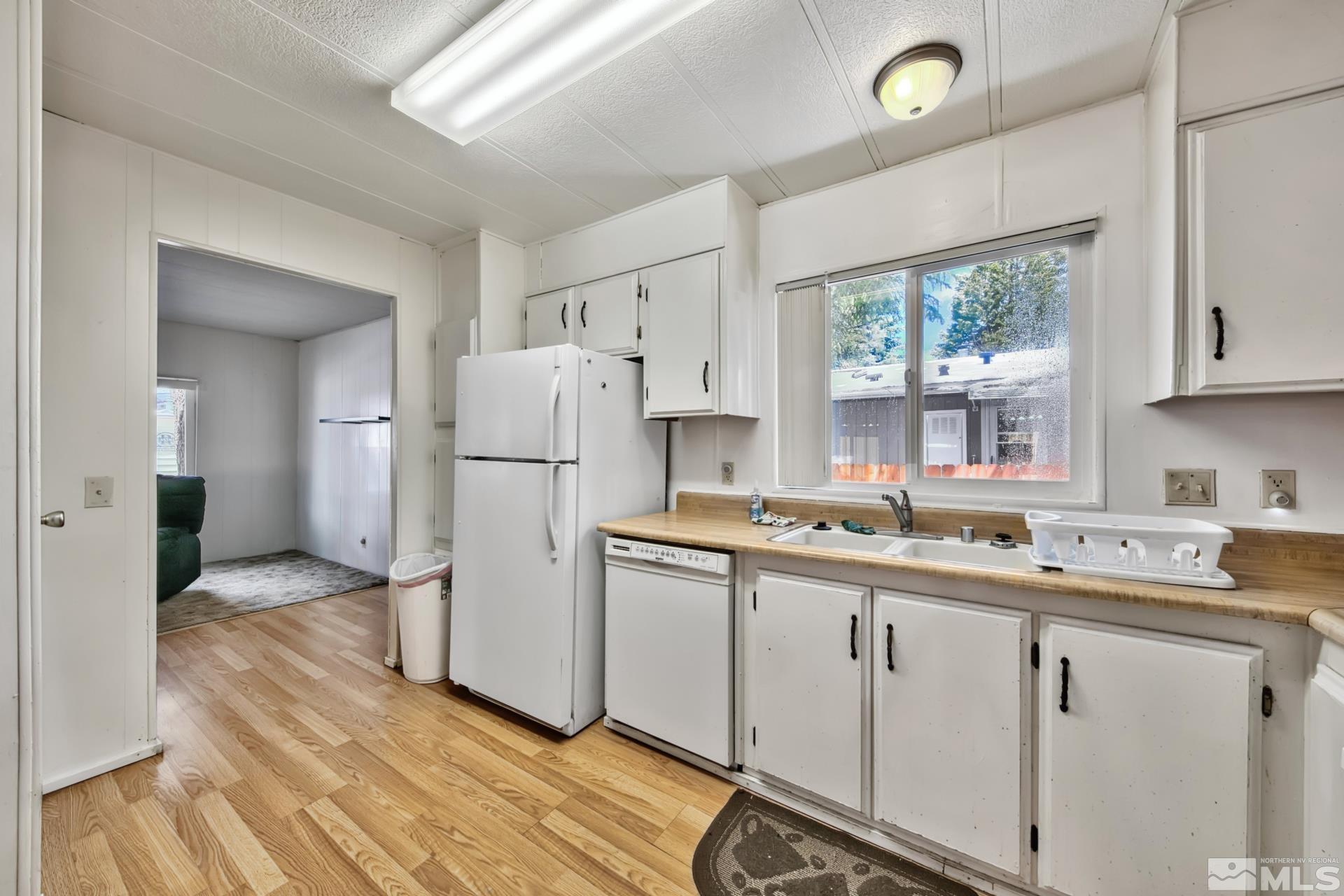 167 Crescent Drive Stateline, NV 89449 - Photo 5 of 23 a kitchen with a sink a refrigerator and a stove