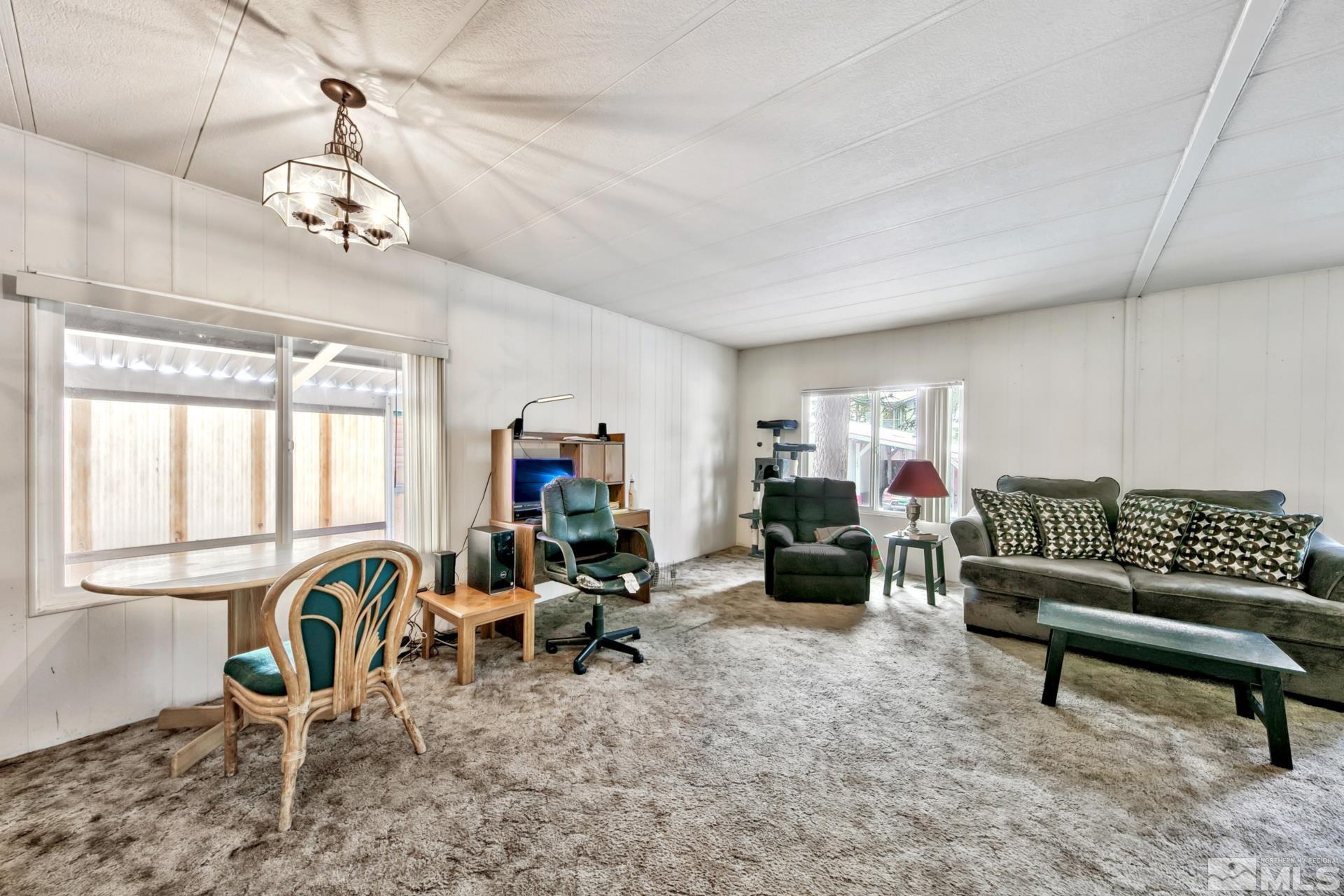 167 Crescent Drive Stateline, NV 89449 - Photo 9 of 23 a living room with furniture a window and a chandelier