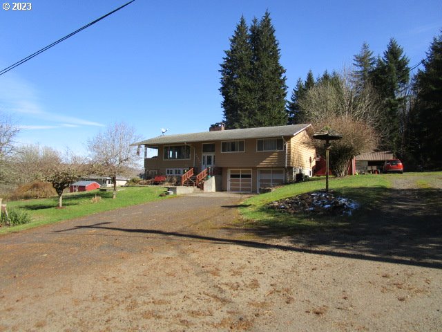 80452 Alston Mayger Road Clatskanie, OR 97016 - Photo 1 of 28 a front view of a house with a yard and garage