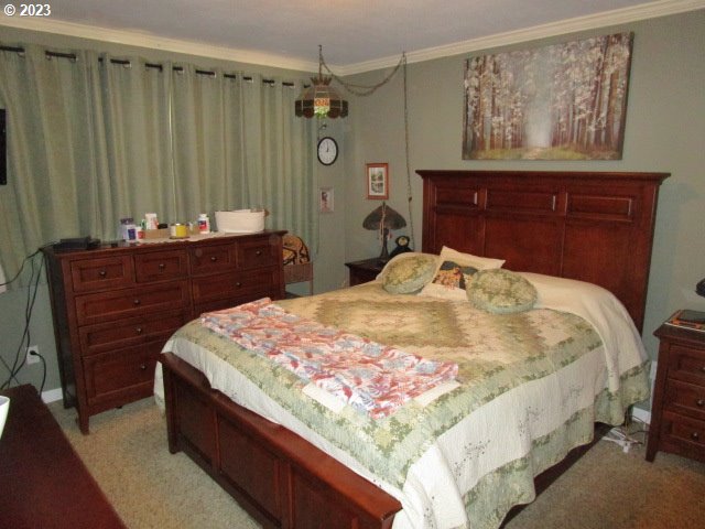 80452 Alston Mayger Road Clatskanie, OR 97016 - Photo 21 of 28 a bed sitting in a bedroom and dresser with wooden floor