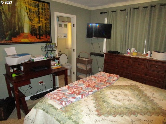 80452 Alston Mayger Road Clatskanie, OR 97016 - Photo 22 of 28 a bedroom with a bed and a flat screen tv