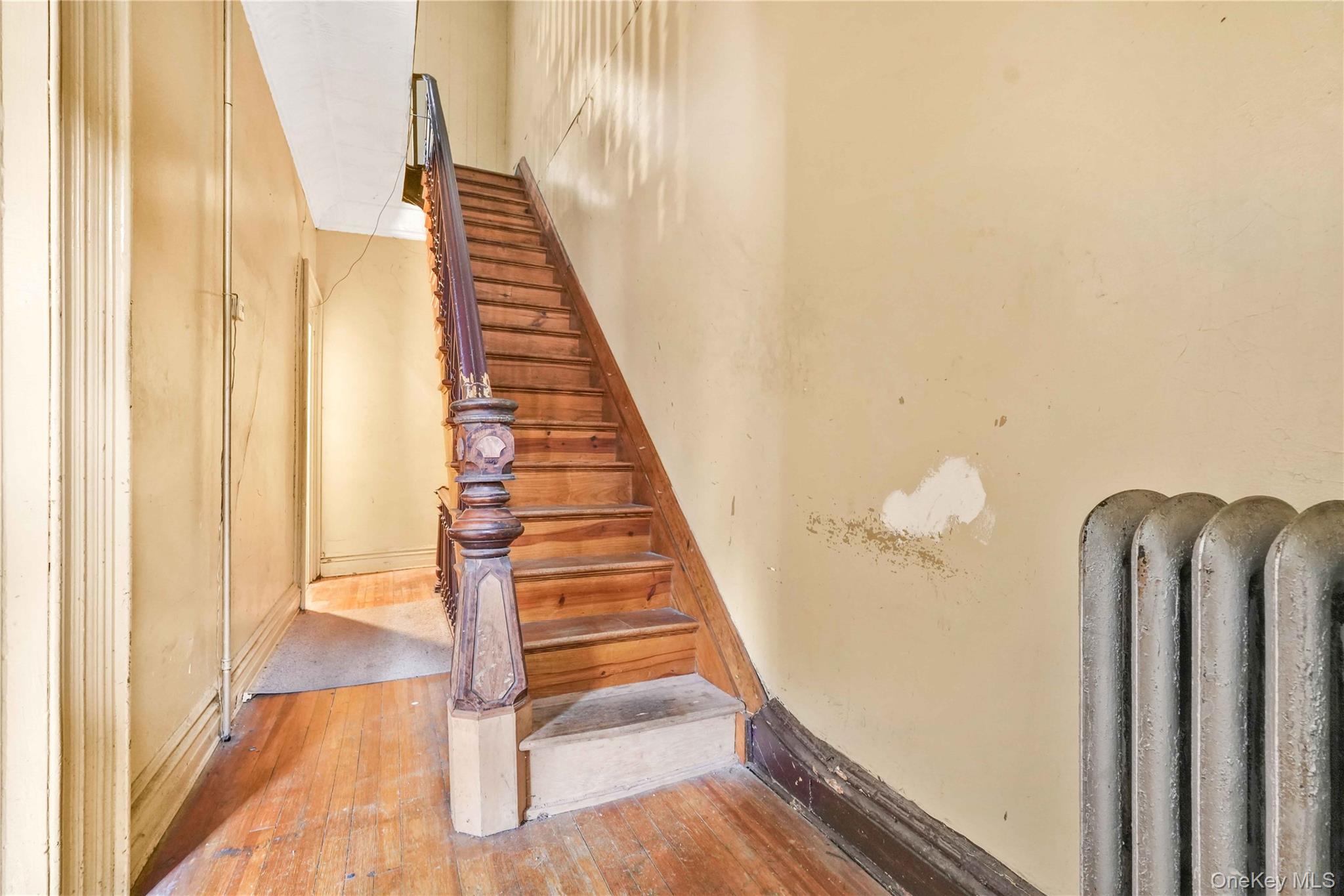 695 Quincy Street Brooklyn, NY 11221 - Photo 4 of 20 a view of a staircase with wooden floor and windows