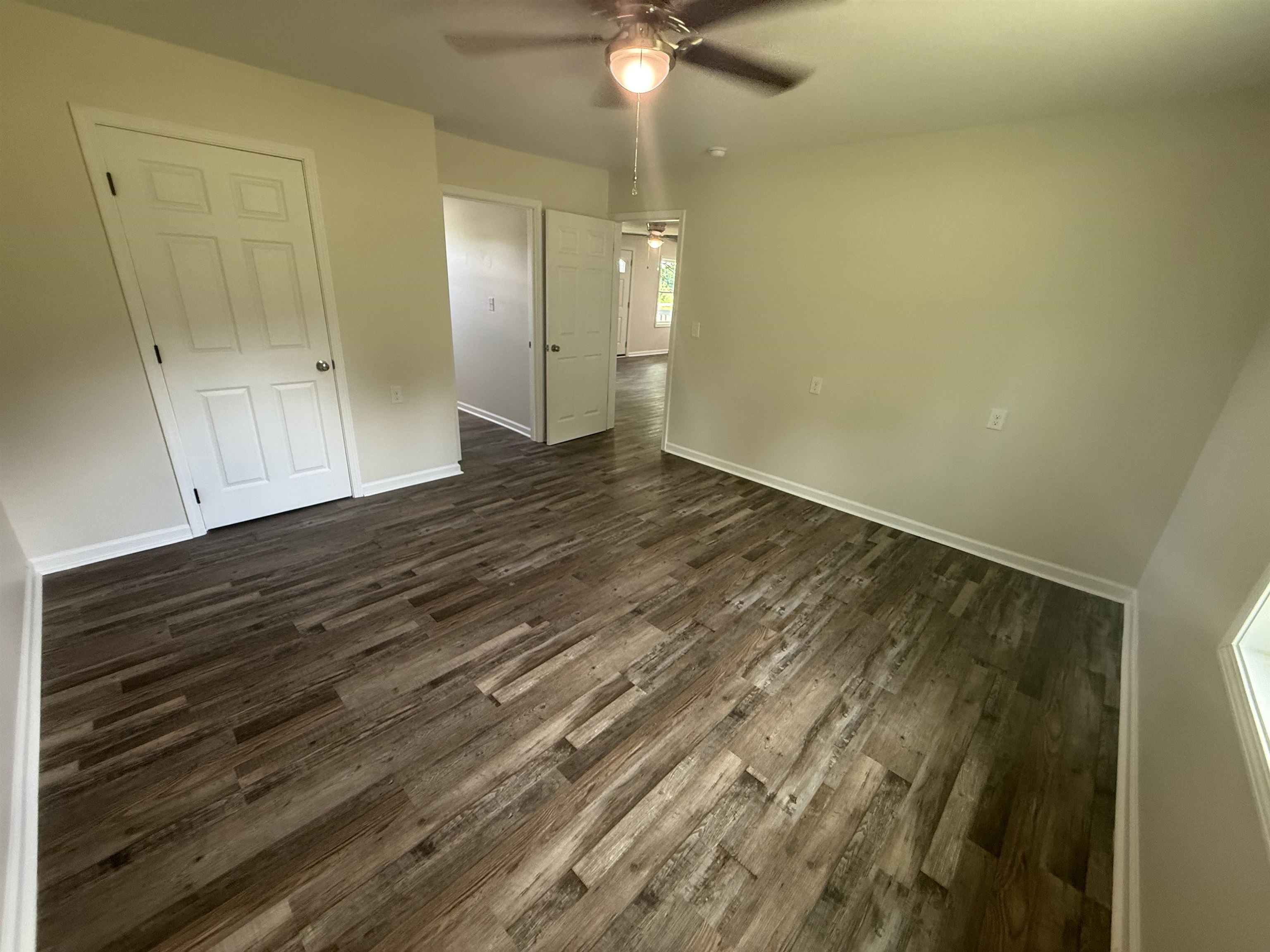 170 Leapwood Road Enville, TN 38332 - Photo 14 of 33 Spacious room featuring wood-finish flooring, light neutral wall paint, and white baseboards
