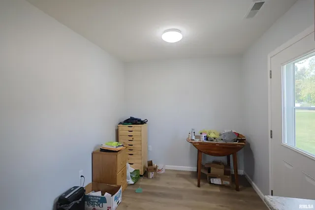 a view of workspace with wooden floor lounge chair and windows