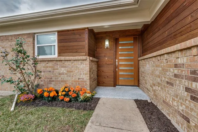a view of front door of house and flowers