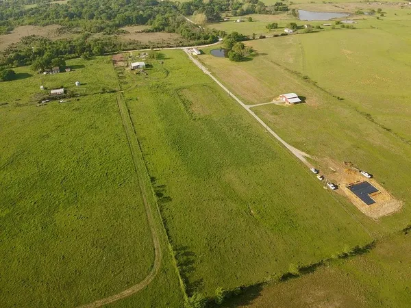 a view of a field with an ocean