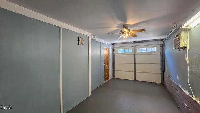 a view of a livingroom with a ceiling fan and window
