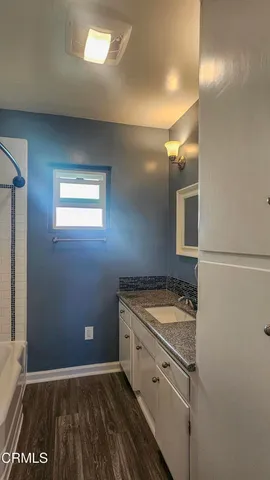 a bathroom with a sink a vanity and a mirror
