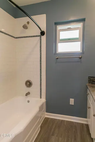 a bathroom with a bathtub and a shower