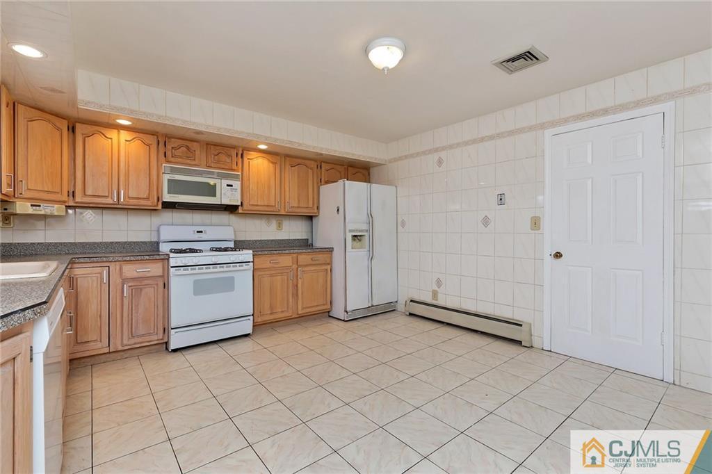 1591 Ridgeway Street Union, NJ 07083 - Photo 11 of 24 a kitchen with white cabinets a sink and white appliances
