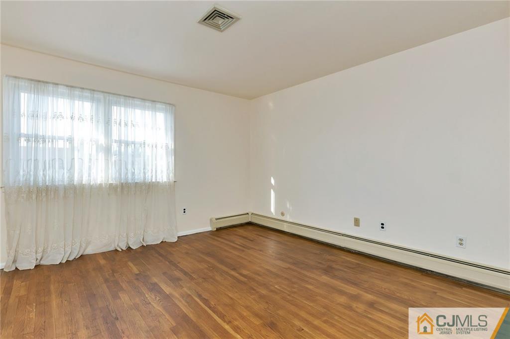 1591 Ridgeway Street Union, NJ 07083 - Photo 12 of 24 an empty room with wooden floor and windows