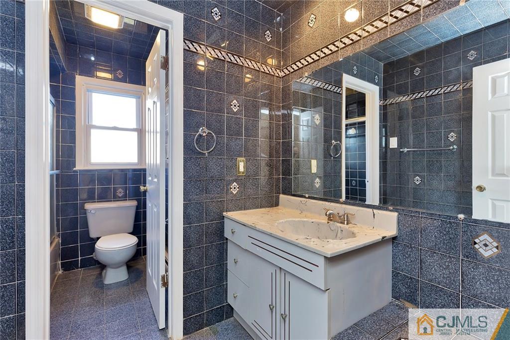 1591 Ridgeway Street Union, NJ 07083 - Photo 13 of 24 a bathroom with a sink a toilet and shower