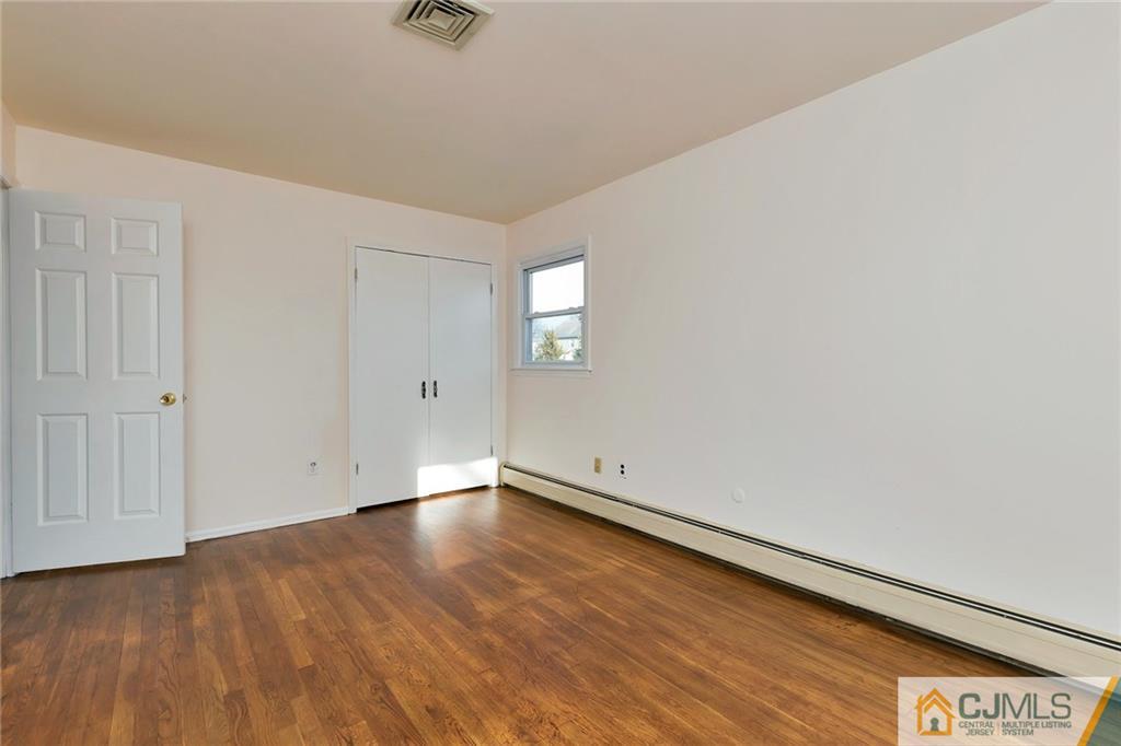 1591 Ridgeway Street Union, NJ 07083 - Photo 15 of 24 an empty room with wooden floor and windows