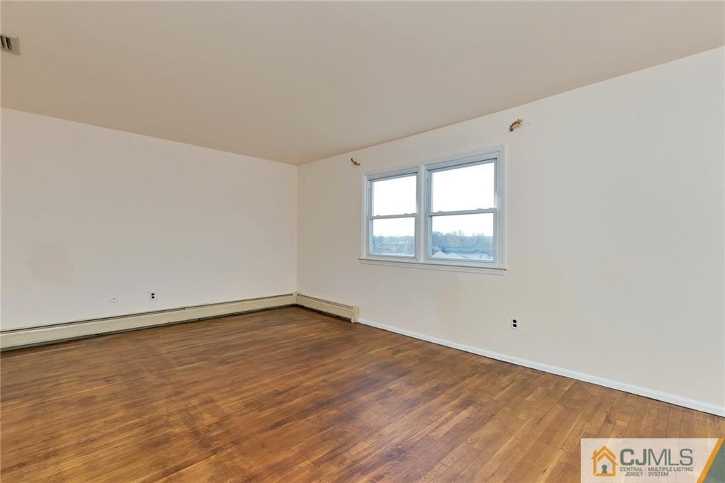 1591 Ridgeway Street Union, NJ 07083 - Photo 17 of 24 an empty room with wooden floor and windows