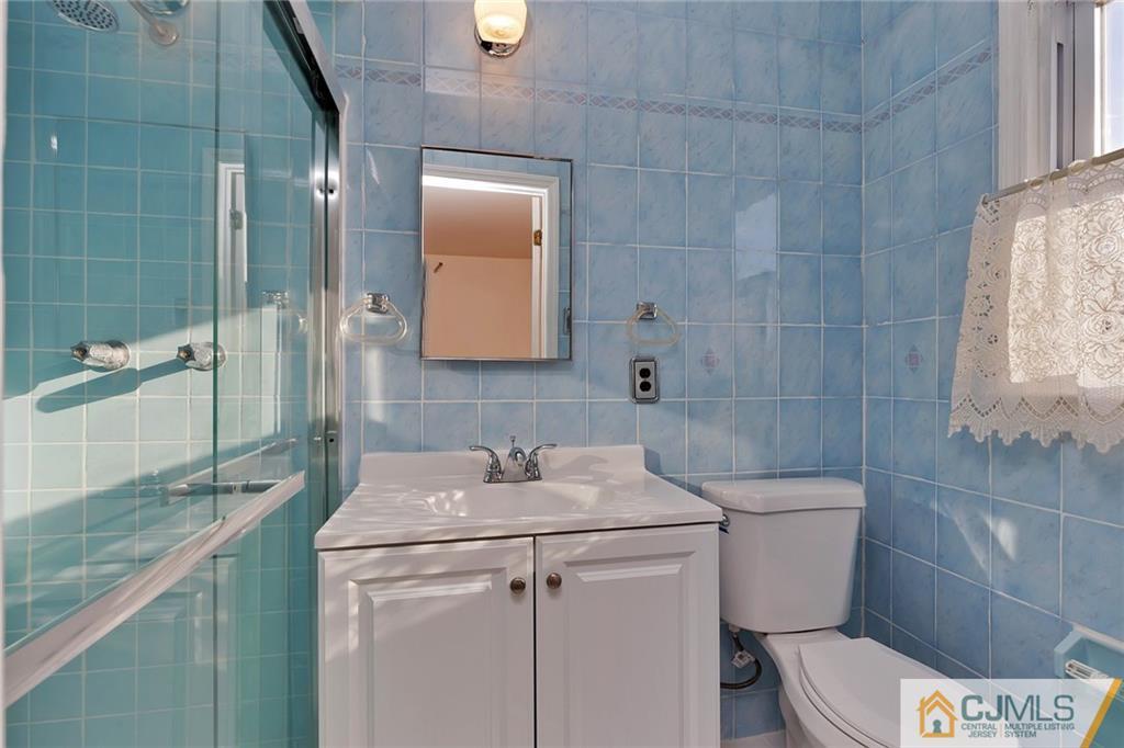 1591 Ridgeway Street Union, NJ 07083 - Photo 18 of 24 a bathroom with a sink a toilet and shower