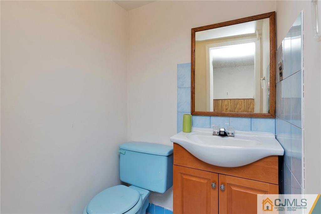 1591 Ridgeway Street Union, NJ 07083 - Photo 20 of 24 a bathroom with a sink a toilet and mirror