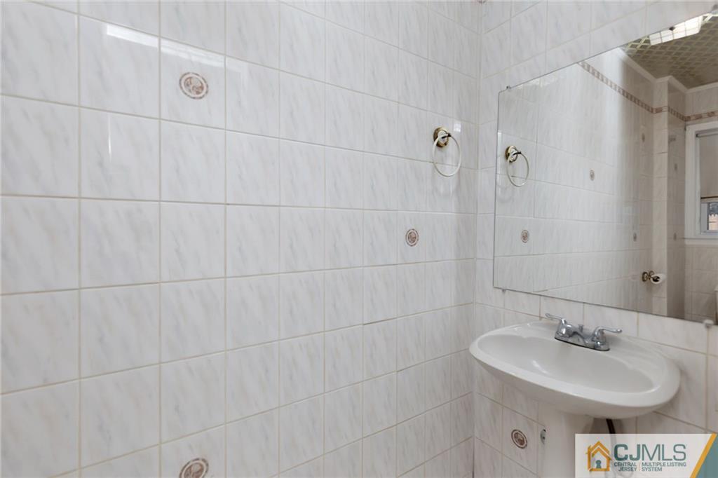1591 Ridgeway Street Union, NJ 07083 - Photo 8 of 24 a bathroom with a sink toilet and shower