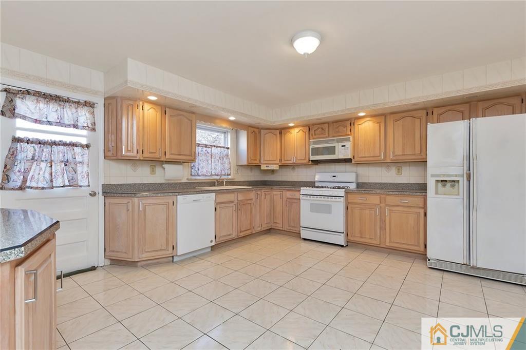 1591 Ridgeway Street Union, NJ 07083 - Photo 9 of 24 a kitchen with a white cabinets and white appliances